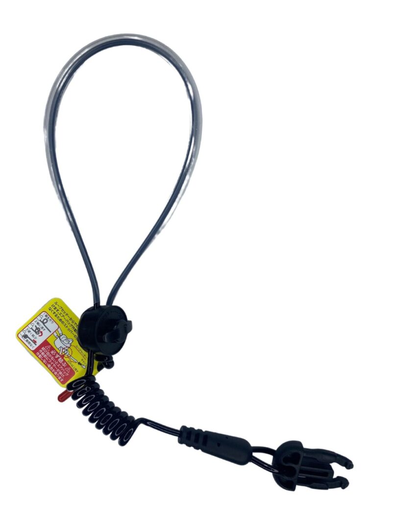 A black and yellow tag hanging from a wire.