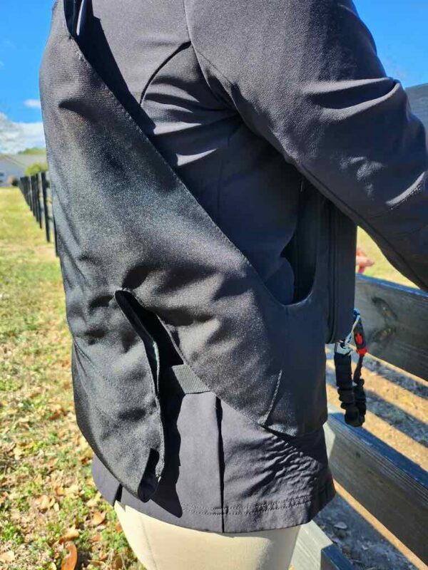 A person with a backpack standing on the side of a bench.
