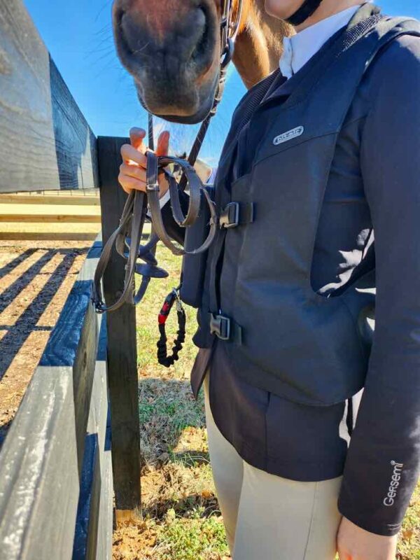 A person holding onto a rope while standing next to a bench.